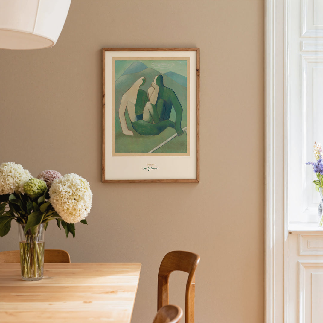Bandits by Mikuláš Galanda Poster framed on beige wall above wooden table with flowers in vase.