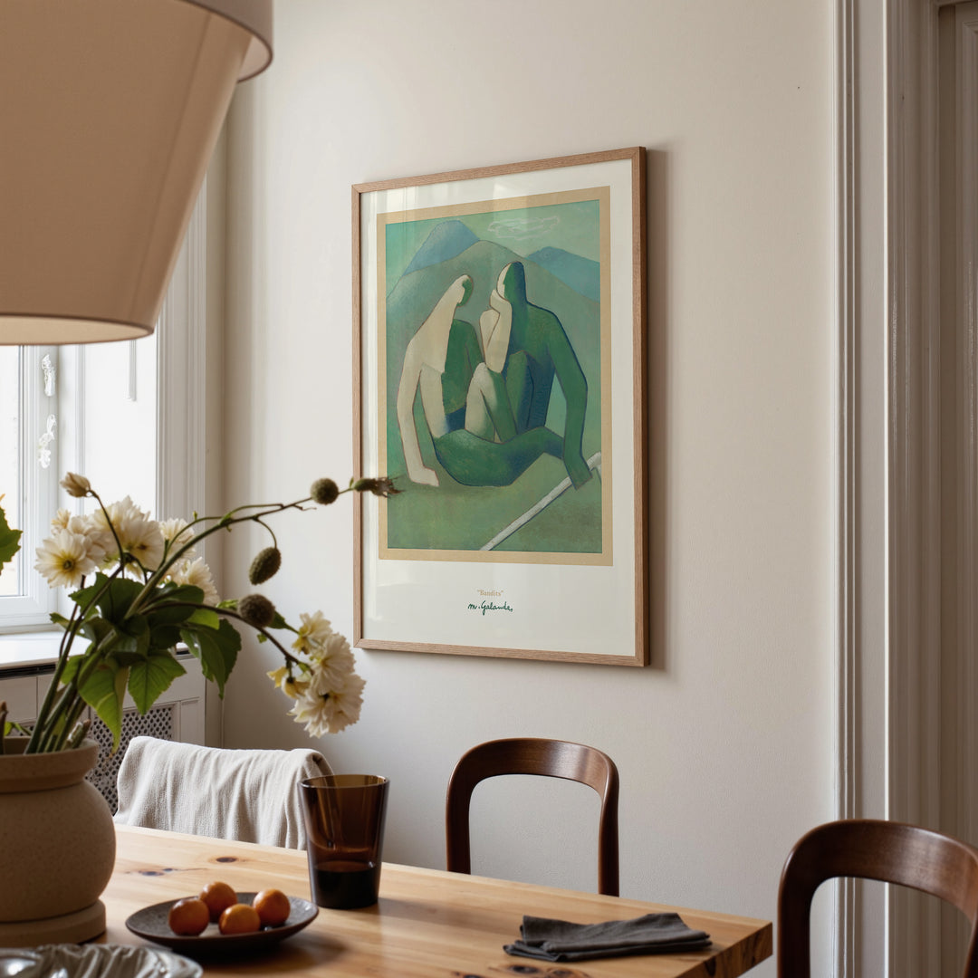 Bandits by Mikuláš Galanda Poster framed and hung on a beige wall above a wooden dining table with flowers and chairs