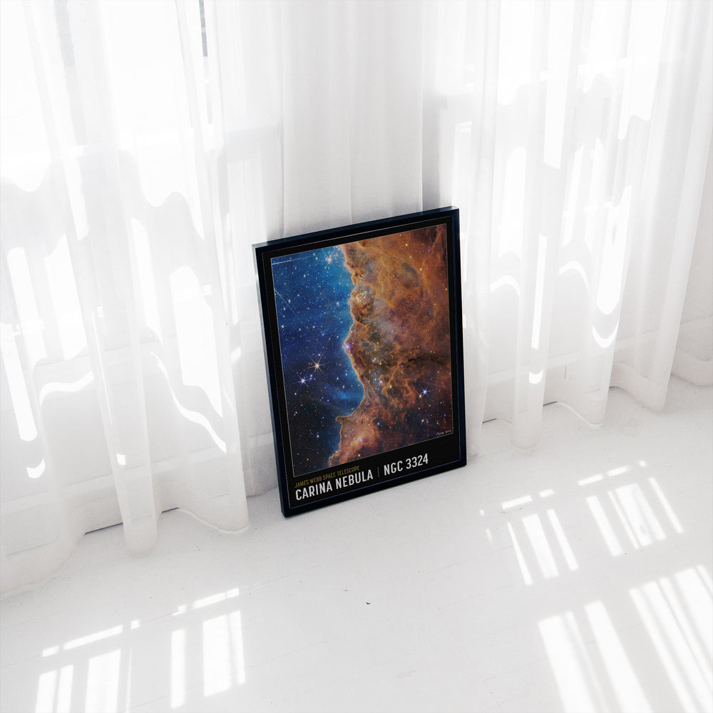 Carina Nebula space poster framed on a wall, warm orange and blue nebula tones, James Webb Telescope imagery