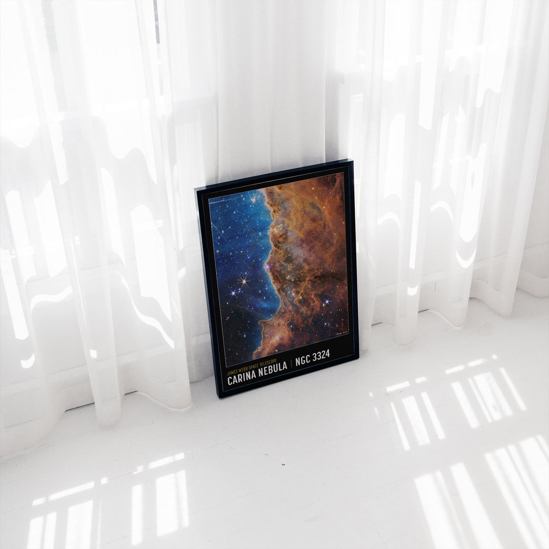 Carina Nebula space poster framed on a wall, warm orange and blue nebula tones, James Webb Telescope imagery