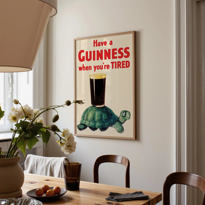 Have a Guinness When You're Tired Poster vintage style with bold red text, green turtle, and dark stout on cream background.