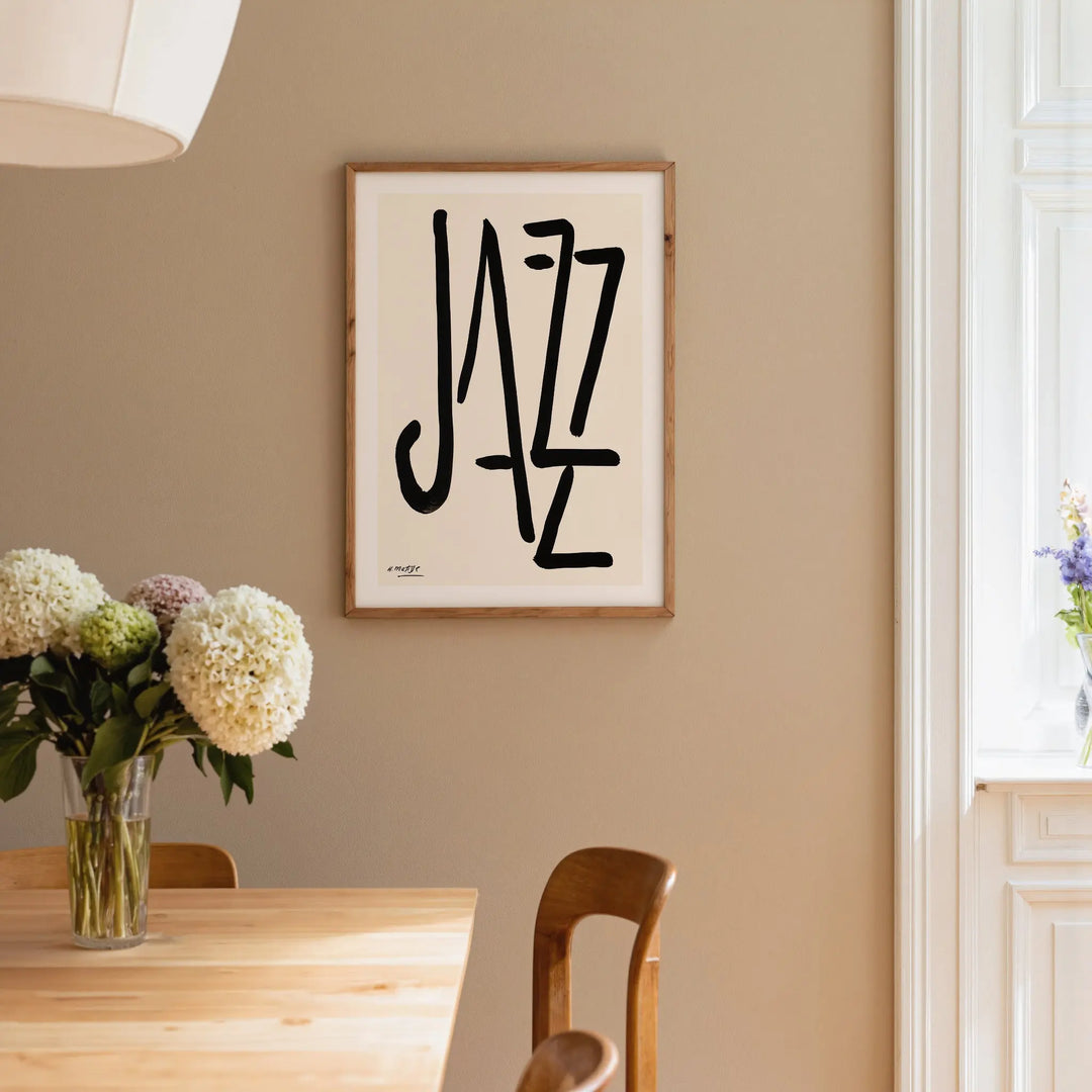 Jazz by Henri Matisse Poster framed on beige wall above wooden table with floral centerpiece and natural light nearby