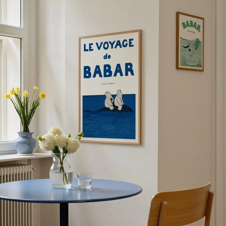 Voyage Babar Poster framed wall art, minimalist vintage style with blue and white tones depicting two elephants on a rock.