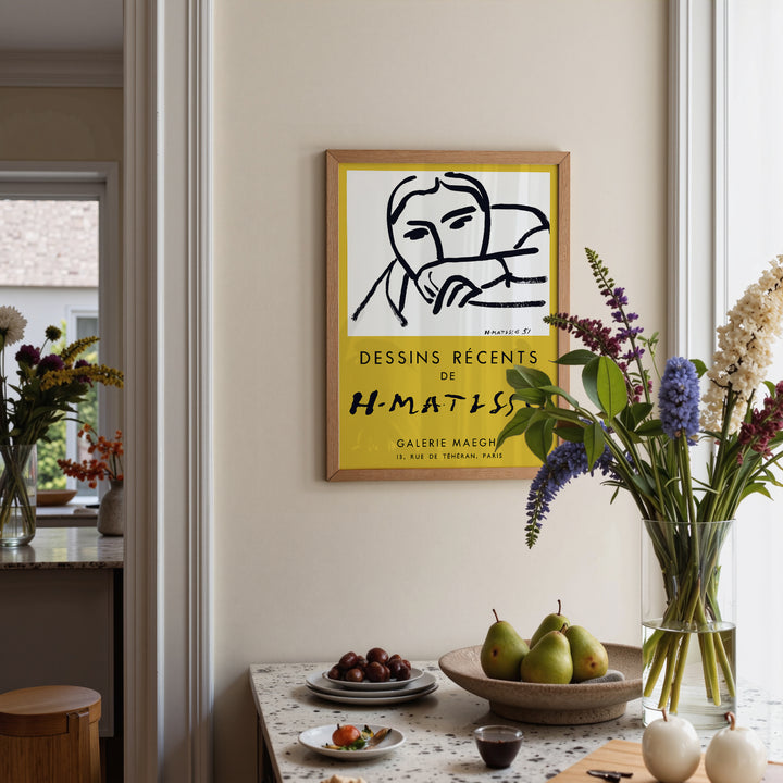 Henri Matisse Gallery Maeght Exhibition Poster framed on a wall above a table with pears and flowers in a vase